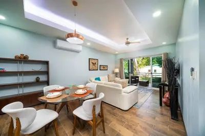 a living room with a couch and a table and chairs at Condo Casa Blanca 7 - NEW 2 BR condo, near to the beach in Potrero