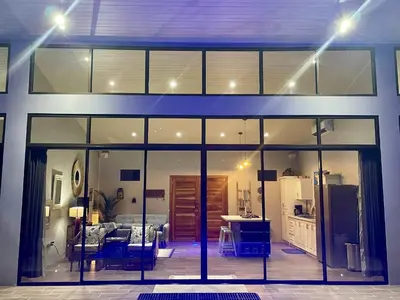 a view of a house with sliding glass doors at An abundance of wildlife at Jungle Glory Home Abajo in Manuel Antonio