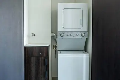 a kitchen with a white refrigerator and a microwave at Rooftop and city view Aparment in San José