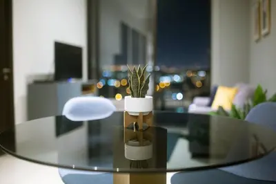 a glass table with a potted plant on top of it at Rooftop and city view Aparment in San José