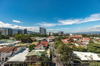 an aerial view of a city with buildings and trees at Rooftop and city view Aparment in San José