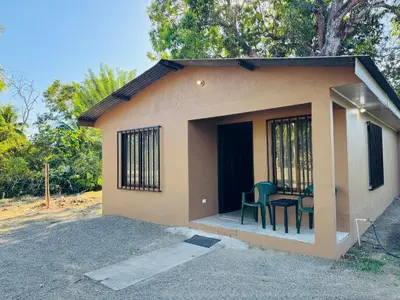 a small house with a table and chairs in it at Casa Ara Macao in Paquera