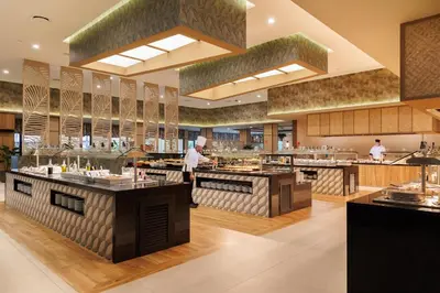 a kitchen with chefs preparing food in a restaurant at Riu Guanacaste - All Inclusive in Coco