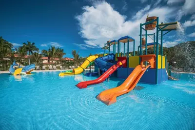 a water park with slides in a swimming pool at Riu Guanacaste - All Inclusive in Coco