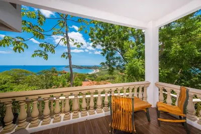 a balcony with a view of the ocean at Casa Del Mar - 4 Br House In Flamingo in Playa Flamingo