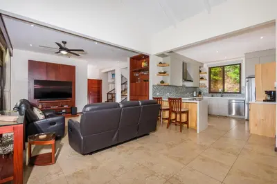 a living room with a couch and a kitchen at Casa Del Mar - 4 Br House In Flamingo in Playa Flamingo