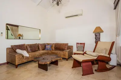 a living room with a brown couch and chairs at Casa Del Mar - 4 Br House In Flamingo in Playa Flamingo