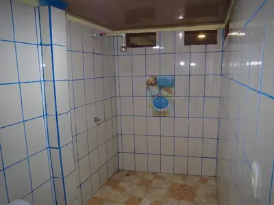 a bathroom with a shower with white tiles at House la Rose Second Floor in Manuel Antonio