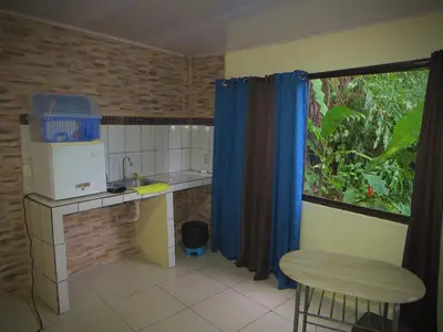 a small kitchen with a counter and a window at House la Rose Second Floor in Manuel Antonio