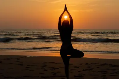 a woman doing yoga on the beach at sunset at Villas VR Beachwalk Avellanas in Playa Avellana
