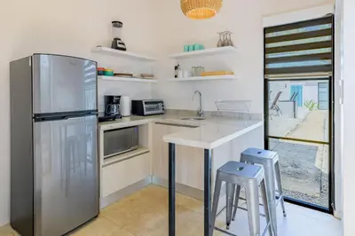 a kitchen with a stainless steel refrigerator and a counter at Villas VR Beachwalk Avellanas in Playa Avellana