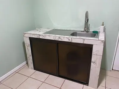 a kitchen with a sink and a counter top at Navapart in San Isidro