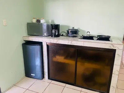 a kitchen with a counter with a microwave and a stove at Navapart in San Isidro