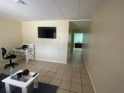 a room with a tv on the wall and a table at Navapart in San Isidro
