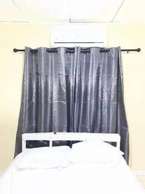 a bed in a room with a black curtain at Navapart in San Isidro