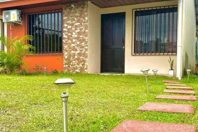 a row of lights in the grass in front of a house at Casa Heliconia- La Fortuna in Fortuna