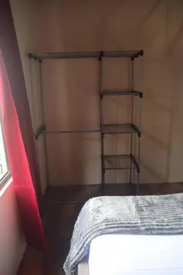 a bedroom with a bed and a book shelf at Casa Heliconia- La Fortuna in Fortuna