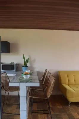 a kitchen with a table and chairs and a couch at Casa Heliconia- La Fortuna in Fortuna