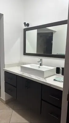 a bathroom with a white sink and a mirror at Beautiful newly refurbished 2 bedroom 2 Bathroom 2nd floor condo in Tamarindo