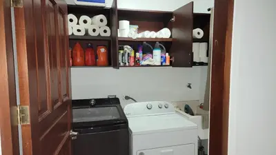 a small kitchen with a stove and a washing machine at Beautiful newly refurbished 2 bedroom 2 Bathroom 2nd floor condo in Tamarindo