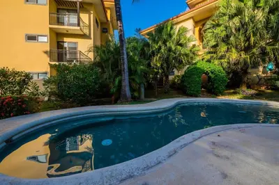 a swimming pool in front of a building at Beautiful newly refurbished 2 bedroom 2 Bathroom 2nd floor condo in Tamarindo