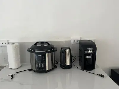 a counter with a toaster and a coffee maker on it at Buganvilla No 4 Aire acondicionado in Quepos
