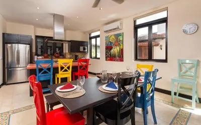 a dining room with a table and colorful chairs at Casa Calle La Ronda At Las Catalinas in Playa Danta