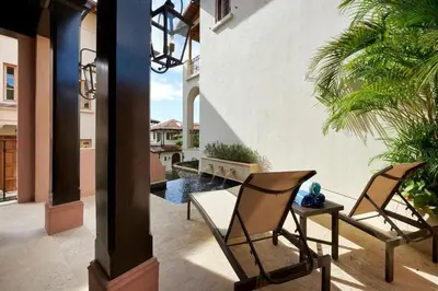 two chairs and a table on a patio with a pool at Casa Calle La Ronda At Las Catalinas in Playa Danta