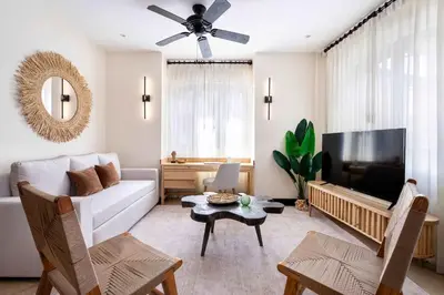 a living room with a white couch and a flat screen tv at Apartment Calle La Ronda At Las Catalinas in Playa Danta