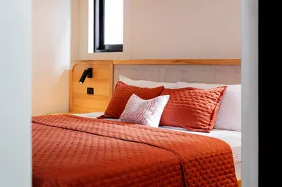 a bedroom with a bed with orange sheets and pillows at Apartment Calle La Ronda At Las Catalinas in Playa Danta