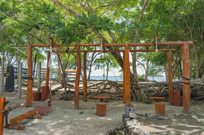 a wooden pavilion with trees and the ocean in the background at Apartment Calle La Ronda At Las Catalinas in Playa Danta