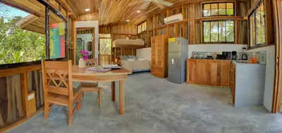 a kitchen and dining room with a table in a house at Sámara Tarantela Houses, Casa Coyol in Sámara