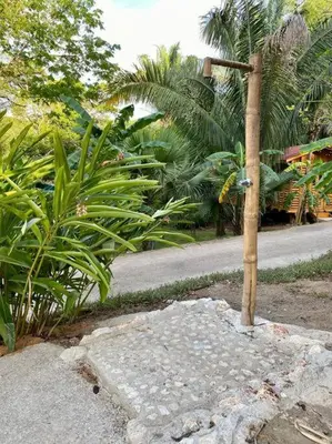 a pole on the side of a road with plants at Sámara Tarantela Houses, Casa Sandal in Sámara