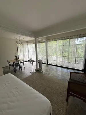 a bedroom with a bed and a table and windows at Casa Mar 1 Manzanillo St Teresa in Boca de Ario