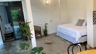 a bedroom with a bed and a chair and a table at Casa Mar 1 Manzanillo St Teresa in Boca de Ario