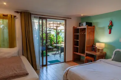 a bedroom with a bed and a sliding glass door at Posada Nena Santa Ana in Santa Ana