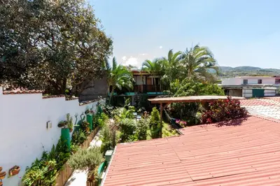 a patio with a roof and a garden at Posada Nena Santa Ana in Santa Ana