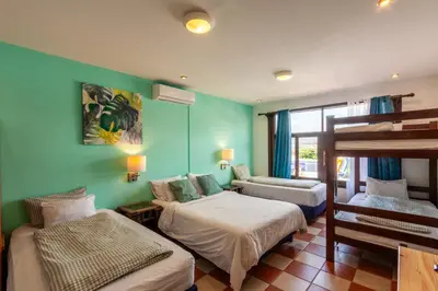 a room with two beds and a bunk bed at Posada Nena Santa Ana in Santa Ana