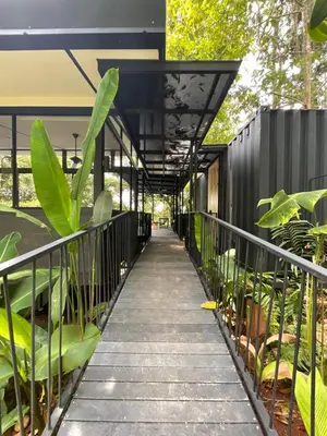 a walkway leading to a building with plants at Casa Alba - Portasol Vacation in Savegre