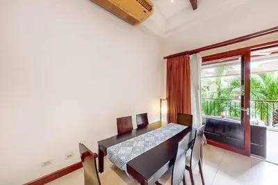 a dining room with a table and chairs and a window at Macaw Oceans Club#20 in Jacó