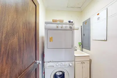 a small kitchen with a white stove and a sink at Macaw Oceans Club#20 in Jacó