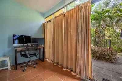 an office with a desk with a computer and a window at Dolce Vita 7025 in Coco