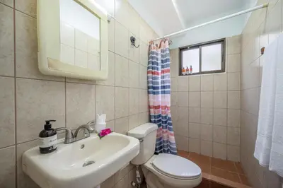 a bathroom with a sink and a toilet and a window at Dolce Vita 7025 in Coco