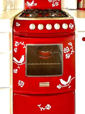 a red stove top oven sitting in a kitchen at Cottage in Magic Mountain Views in Barrio Jesús