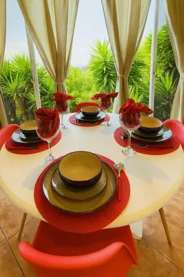 a table with plates and wine glasses on it at Cottage in Magic Mountain Views in Barrio Jesús
